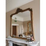 Decorative gilt overmantle mirror {150 cm H x 160 cm W}.