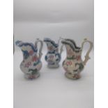 Set of three ceramic water jugs decorated with flowers and grapevines. {23 cm H x 17 cm W x 13 cm
