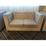 Deep buttoned upholstered and mahogany two seater sofa {61 cm H x 140 cm W x 73 cm D}.