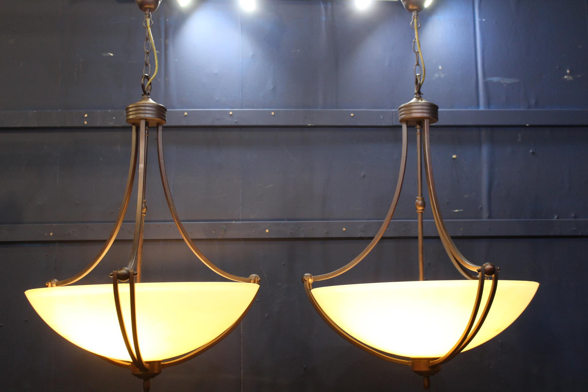 Pair of bronze hanging light with alabaster shades {H 100cm x Dia 56cm}.