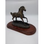 Resin model of a Race Horse mounted on mahogany plaque {16 cm H x 40 cm W x 20 cm D}.