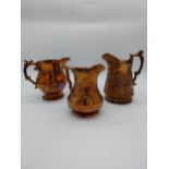 Three 19th C. lusterware jugs. {20 cm H}, {18 cm H} and {17 cm H}.