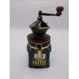 Ceramic and brass coffee grinder {25 cm H x 13 cm W x 13 cm D}.