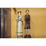Pair of wooden figurines of a lady and gentleman {H 37cm x Dia 9cm}.