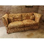 Decorative cream and red upholstered two seater couch with cushions, with drop down sides in the