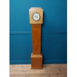 Art Deco oak Grand Daughter clock with enamel dial {151 cm H x 26 cm W x 14 cm D}.