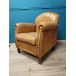 Exceptional quality 1940s tanned leather club chair with brass studs raised on square tapered