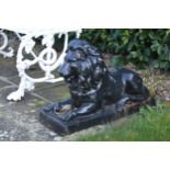 Pair cast iron models of recumbent Lions. {42 cm H x 65 cm W x 23 cm D}.