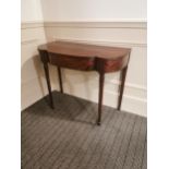 Edwardian mahogany serpentine front side table raised on turned tapered reeded legs {74 cm H x 90 cm