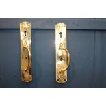 Pair of brass door latches {H 30cm x W 5cm x D 6cm}.