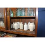 Collection of twenty earthenware stone bottles {H 14cm down to H 12cm}.