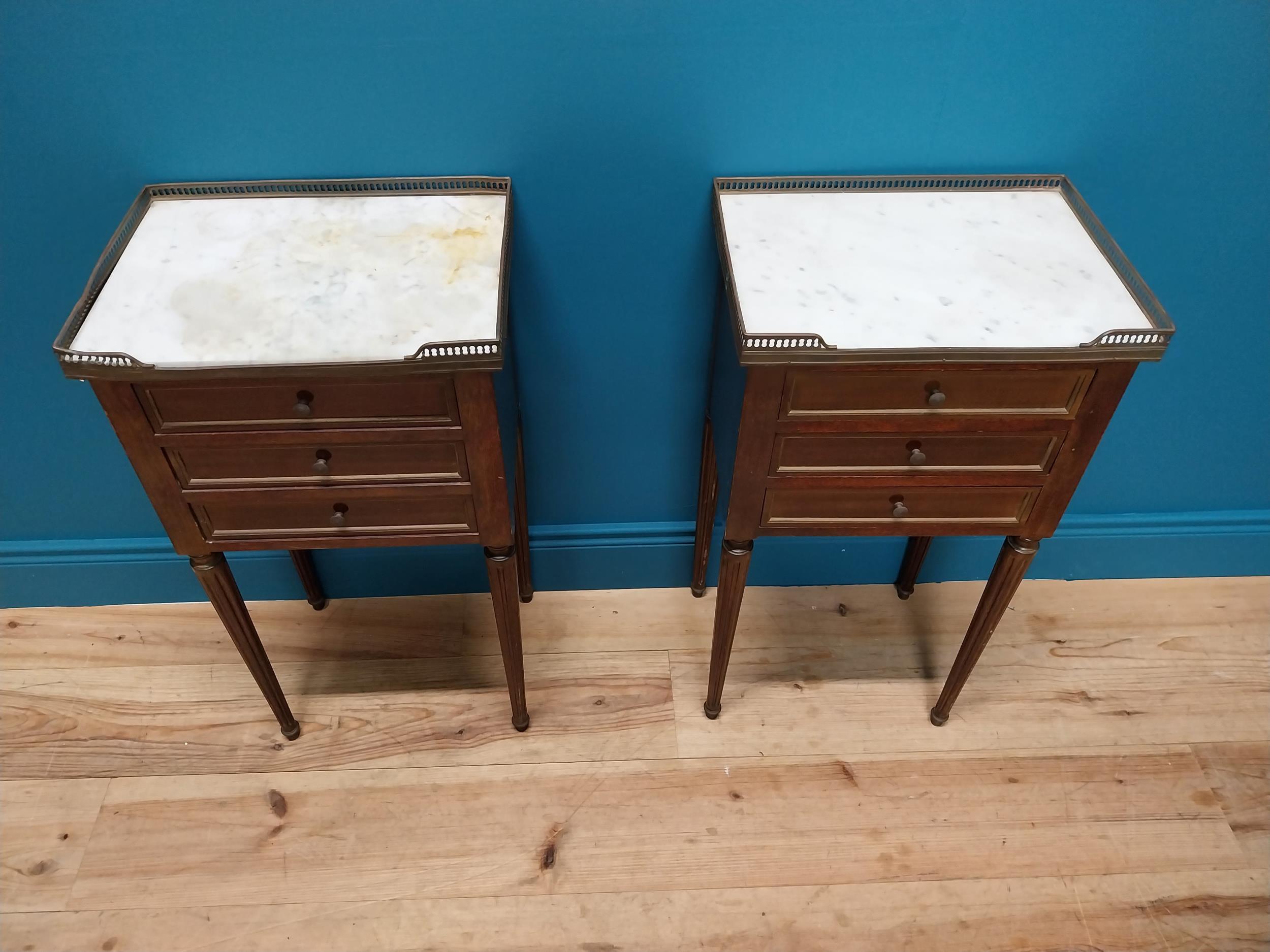 Pair of 19th C. mahogany and brass bedside lockers with inset marble top and three drawers raised on - Image 2 of 5