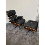 Black leather chair with matching stool raised on chrome base in the Eames style.