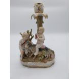 Decorative ceramic candelabra decorated with cherubs. {30 cm H x 20 cm W x 12 cm D}.