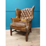 Early 20th hand dyed cigar leather deep buttoned wingback armchair {106 cm H x 80 cm W x 79 cm D}.