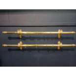 Pair of brass curtain rails with acanthus leaf design {Each H 16cm x W 124cm x D 14cm}.