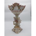 Decorative ceramic centrepiece decorated with Grecian Lady, cherubs and floral swags with damage. {