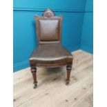 19th C. oak and leather upholstered side chair raised on reeded legs and brass castors {100 cm H x