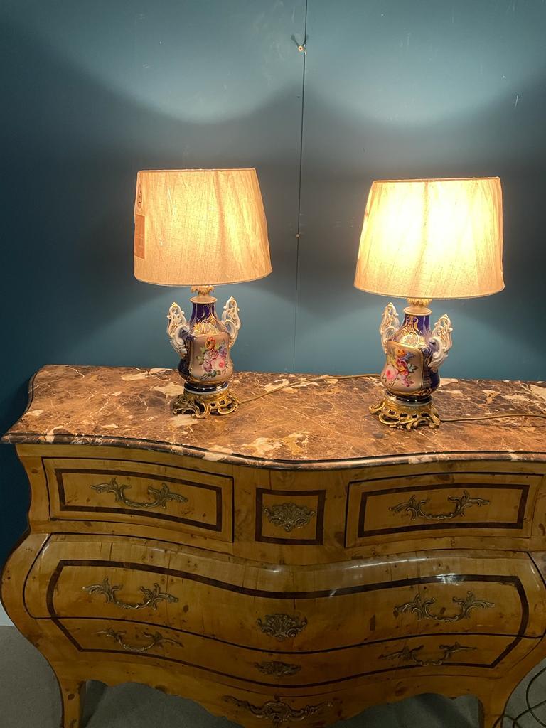 Pair of 19th. C. hand painted ceramic table lamps mounted on gilded bases the cartouches decorated