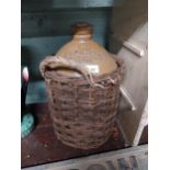 D and D McAllister Wine and Spirit Merchants Belfast stoneware flagon in original basket. {41 cm H x