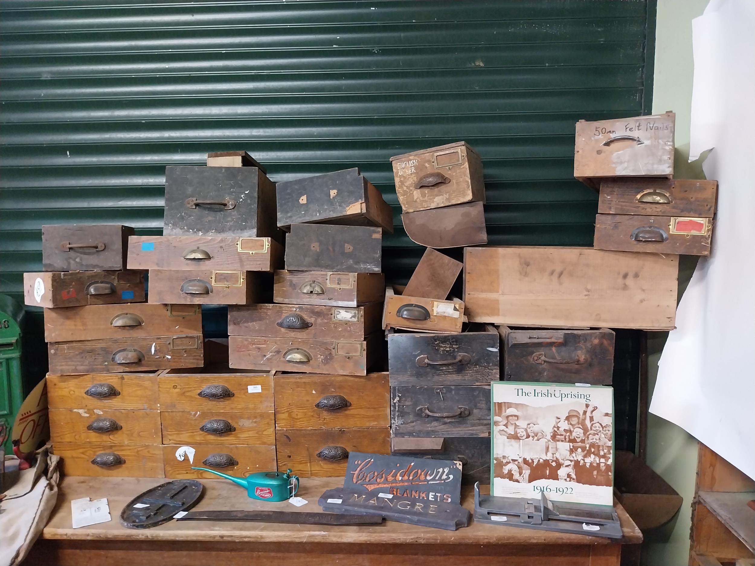 Collection of thirty five early 20th C. pine shop drawers with original metal and brass handles.