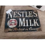 Nestle's Milk enamel advertising sign. {14 cm H x 20 cm W}.
