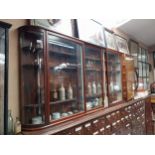 Early 20th C mahogany wall mounted glazed chemist cabinet {102cm H x 252cm W x 36cm D}