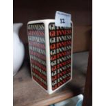 Two ceramic Guinness advertising lighters and pepper pot. {13 cm H x 7 cm W x 7 cm D}.