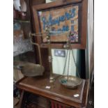 19th C. brass shop scales on mahogany base. {61 cm H x 60 cm W x 30 cm D}.