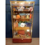 Brass glazed shop cabinet display with single drawer on brass feet with lights {H 190cm x W 90cm x D