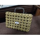 Handbag fashioned from Guinness bottle tops. {23 cm H x 28 cm W x 8 cm D}.