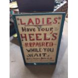Ladies Have your Heels repaired while you wait Lenord Faird framed tin plate advertising sign. {69