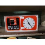 Draught Guinness Perspex battery operated advertising clock. {18 cm H x 36 cm W x 7 cm D}.