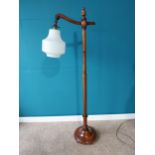 Edwardian mahogany standard lamp with milk glass shade {150 cm H x 50 cm W}.