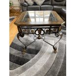 Steel coffee table with inset leather and glass top raised on cabriole legs and brass lions feet.