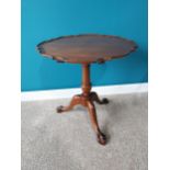 Mahogany pie crust lamp table raised on turned column, three outswept feet and ball & claw feet in