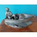 Resin model of a fisherman and dog in his boat {15cm H x 30cm W x 17cm D}
