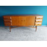 Mid-century teak sideboard with two blind doors flanked by six drawers raised on tapered legs.