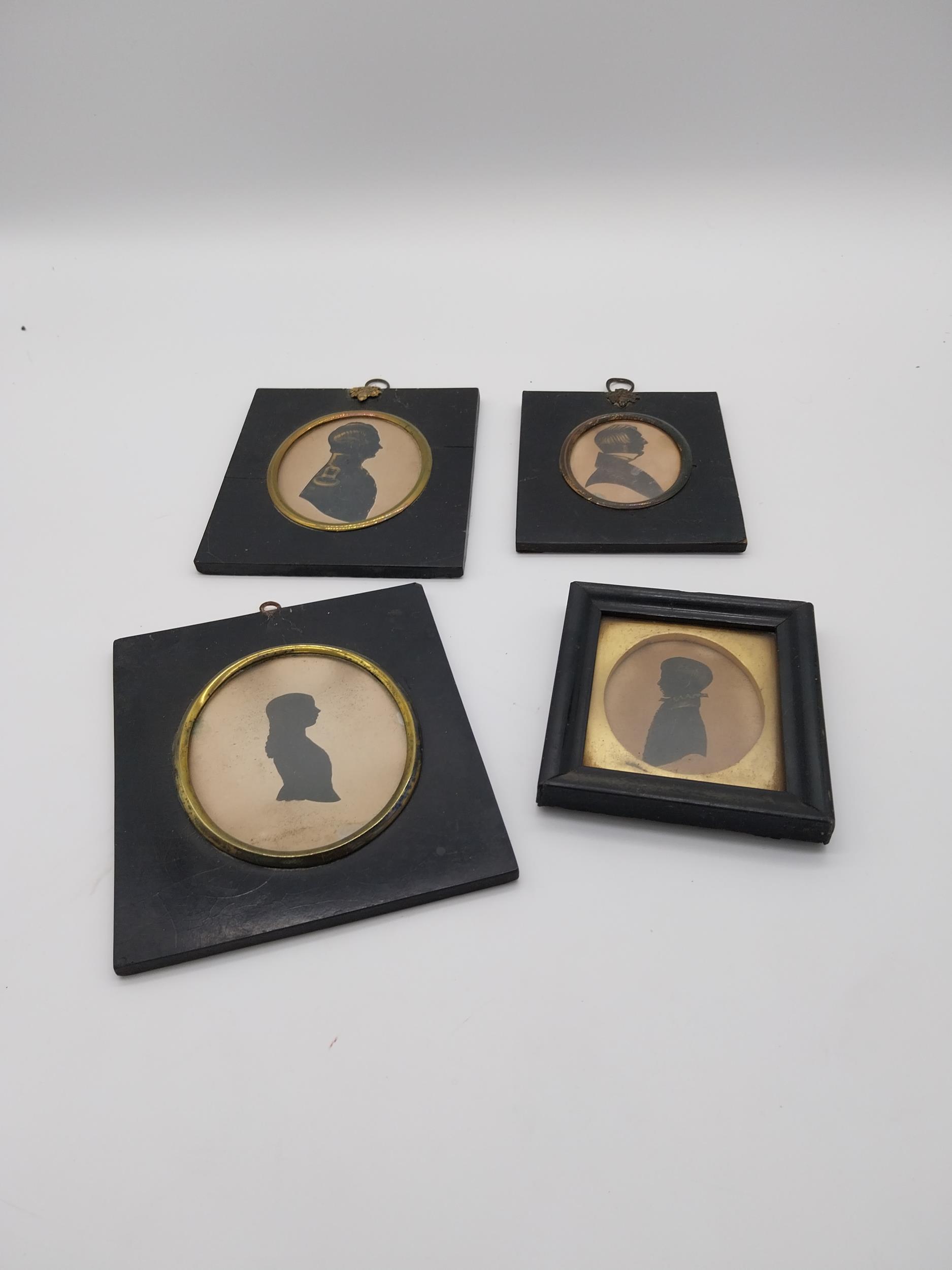 Collection of four 19th C. silhouettes mounted in ebonised frames {Largest 15 cm H x 13 cm W and