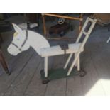 Early 20th. C. Wooden child's horse on wheels { 68cm H X 83cm W X 14cm D }.