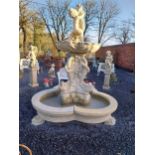 Good quality composition garden fountain decorated with cherubs and carp on lion's paw feet. {245 cm