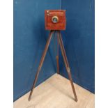 Vintage instant full plate field camera on original tripod leg sin mahogany, brass fittings with