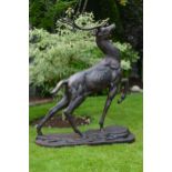 Lifesize cast iron model of a Deer with raised hoof on oval plinth. {153cm H x 120cm W x 55cm D}