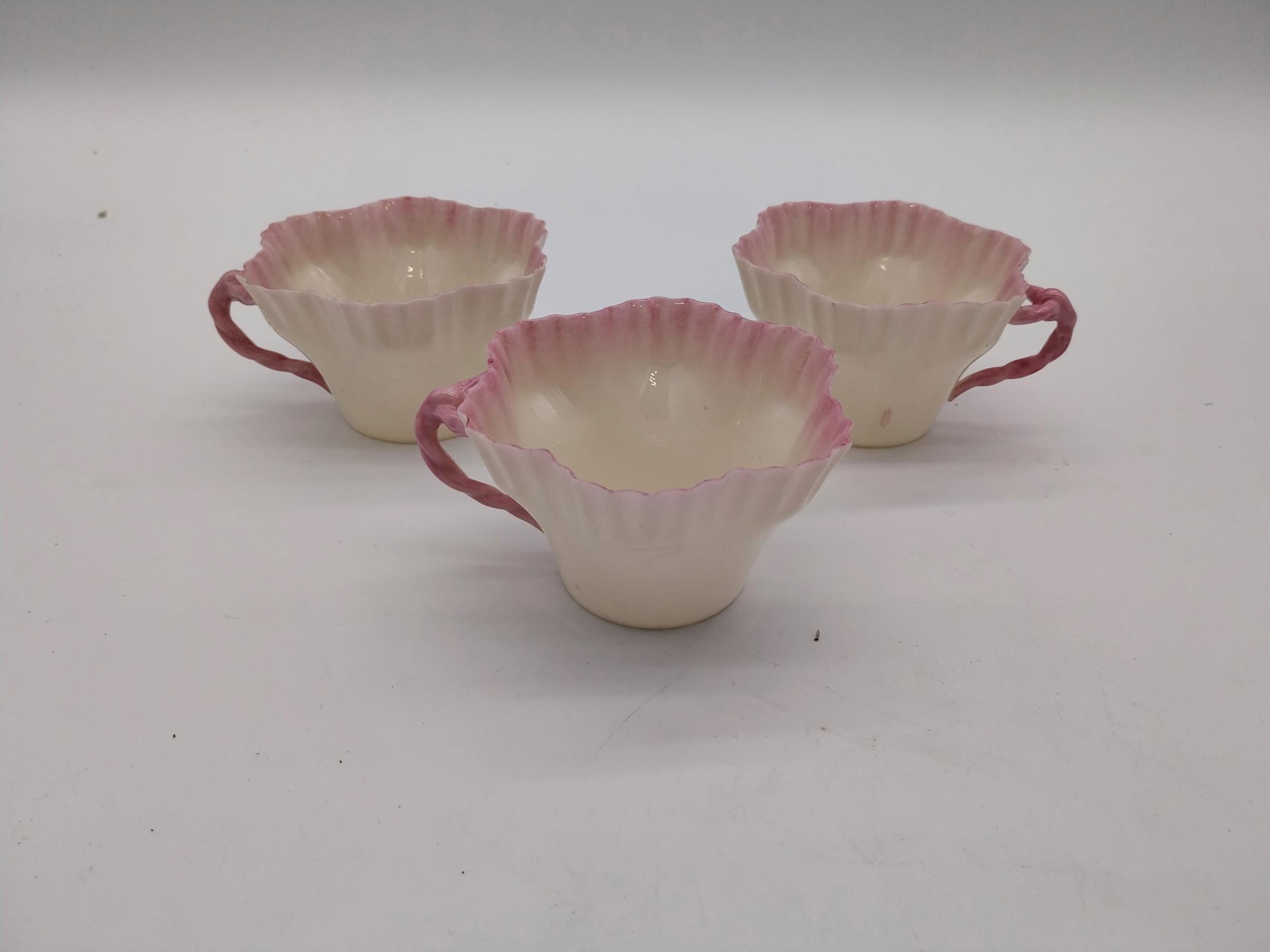 Three second period Belleek black stamp tea cups. { 6cm H X 10cm W X 9cm D }.