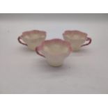 Three second period Belleek black stamp tea cups. { 6cm H X 10cm W X 9cm D }.