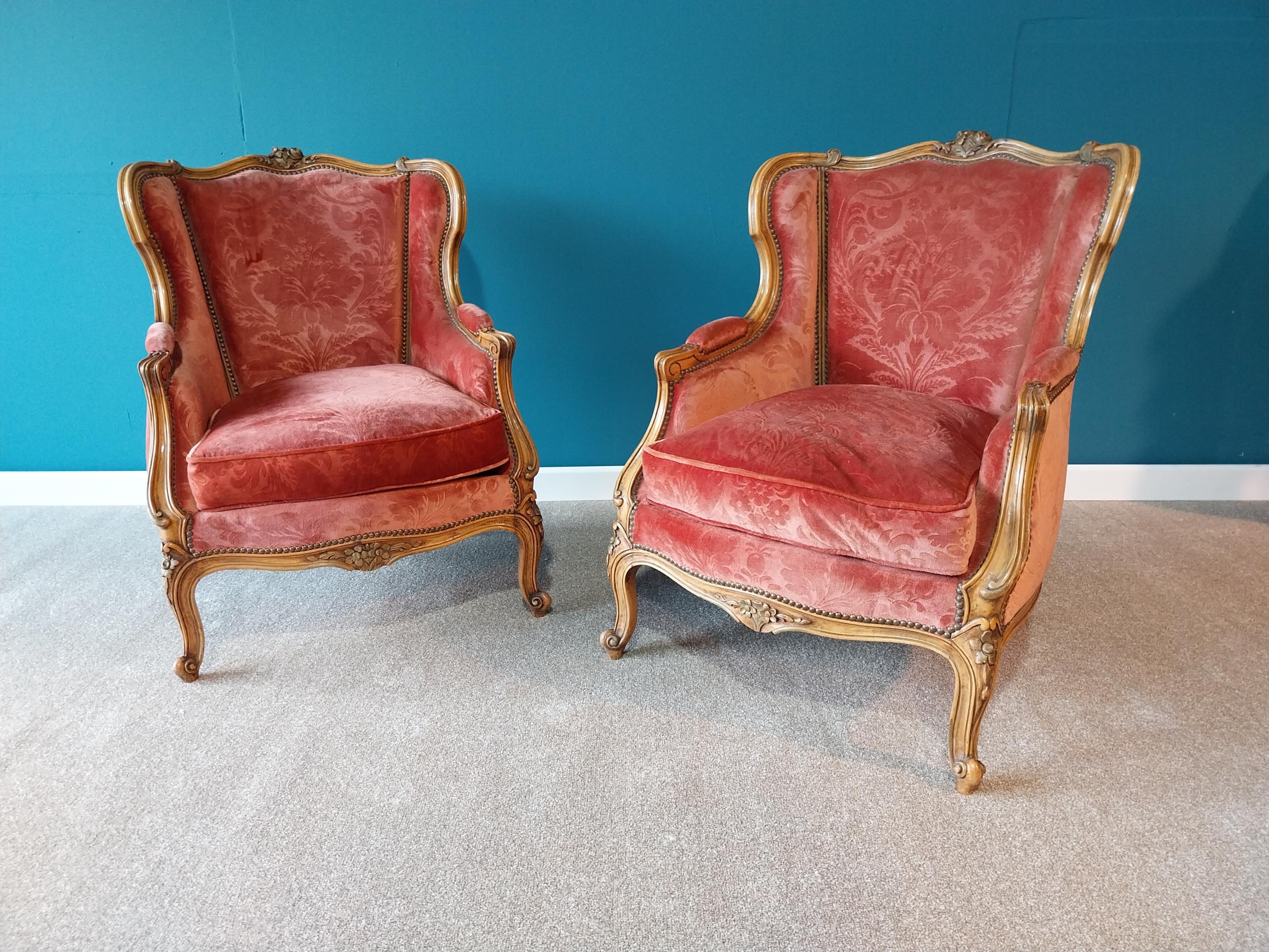 Good quality pair of His and Hers French Edwardian carved walnut and upholstered armchairs raised on