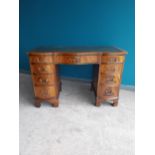 Good quality Edwardian mahogany serpentine front desk with inset leather top raised on bracket