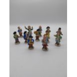 Set of twelve early 20th. C. Sitzendorf porcelain figures Monkey Band stamped with blue crowned