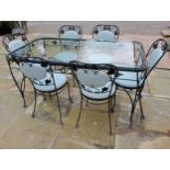 Wrought iron table and glass top and six chairs with leather seat and back {Table H 75cm x W 152cm x