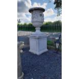 Pair of monumental composition urns raised on pedestals in the Georgian style